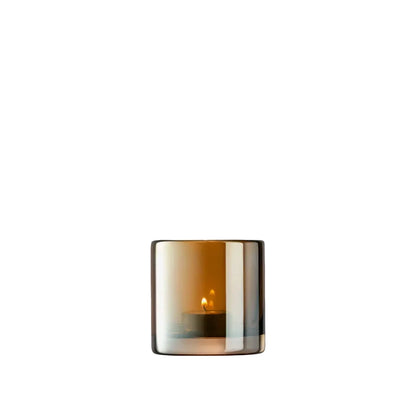 A handcrafted glass tealight holder with a translucent orange and gray color, featuring a mouth-blown design with a thick base.