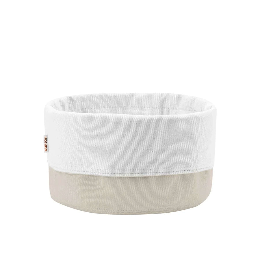 White fabric basket with beige base on a white background