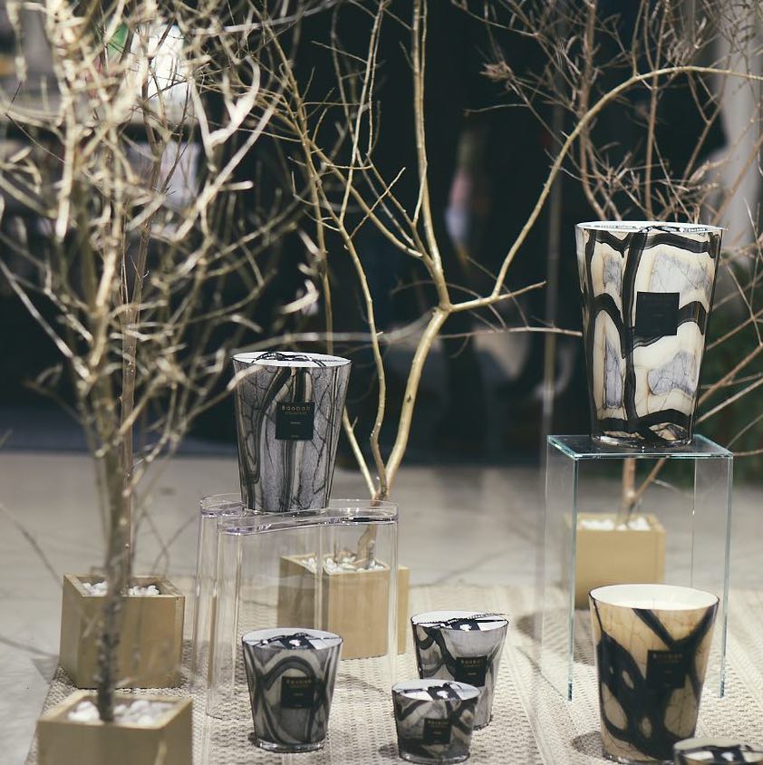 scented candles-Decorative candles and vases on a table with a blurred background