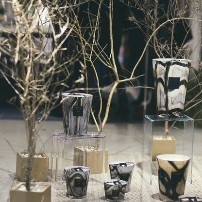 scented candles-Decorative candles and vases on a table with a blurred background