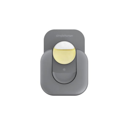 Gray motion sensor with a yellow light on a white background