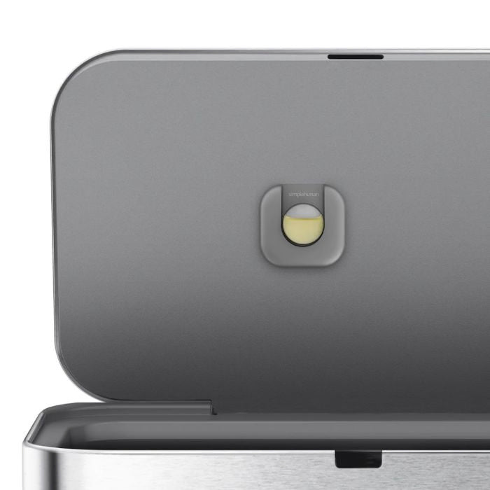 simplehuman Voice and Motion Sensor Bin, Rectangular-Close-up of a metallic appliance with a button on a white background
