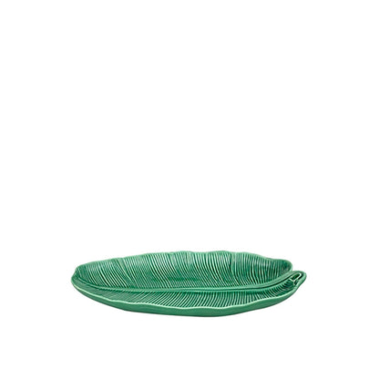Green leaf-shaped plate on a white background