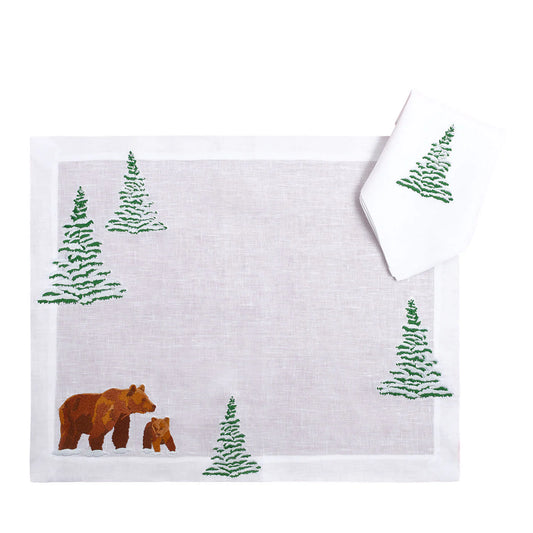 White towel with embroidered bear and tree design on a white background