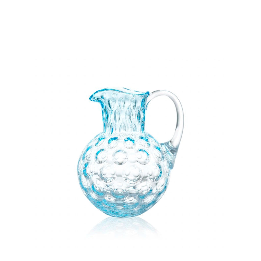 Clear glass pitcher with textured surface on a white background