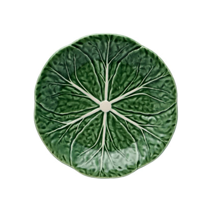 Round green pillow with pleated texture on a white background